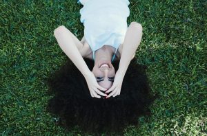 happy woman laying in the grass