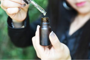 Woman testing a CBD oil's tincture dropper